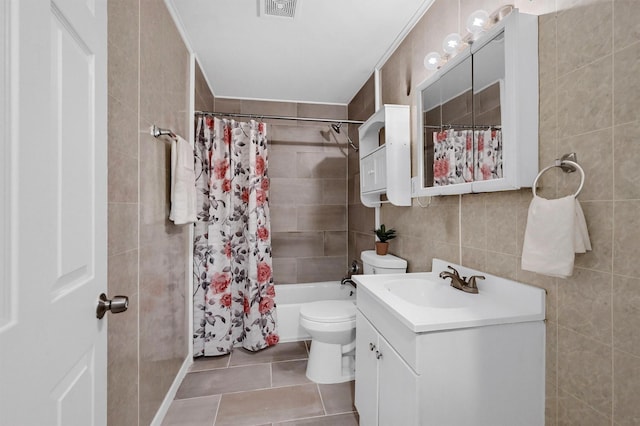 1326 W Shepherd St, Denison, TX 75020 - bathroom featuring tile walls, vanity, tile patterned floors, toilet, and shower / bath combination with curtain
