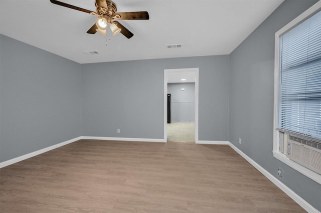 1326 W Shepherd St, Denison, TX 75020 - spare room with a ceiling fan, light wood-style flooring, baseboards, and cooling unit