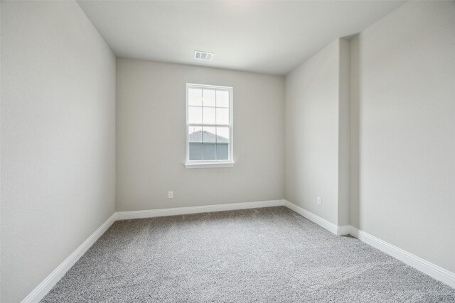 carpeted empty room with baseboards and visible vents