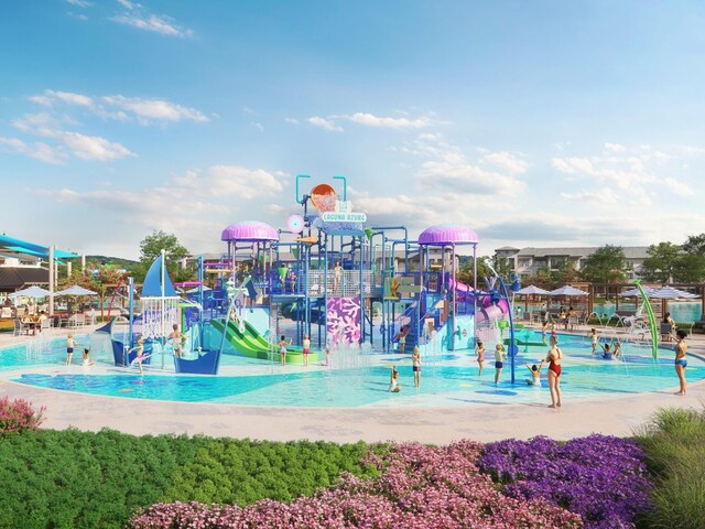 community jungle gym with a community pool and a water play area