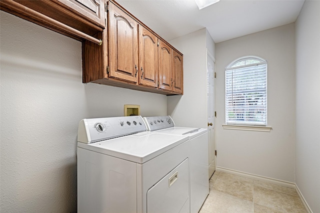 2215 Burgundy Dr, Carrollton, TX 75006 - laundry room featuring cabinet space, baseboards, and separate washer and dryer