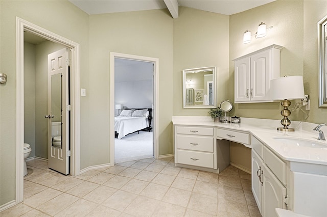 2215 Burgundy Dr, Carrollton, TX 75006 - ensuite bathroom featuring vanity, lofted ceiling with beams, tile patterned flooring, ensuite bath, and toilet