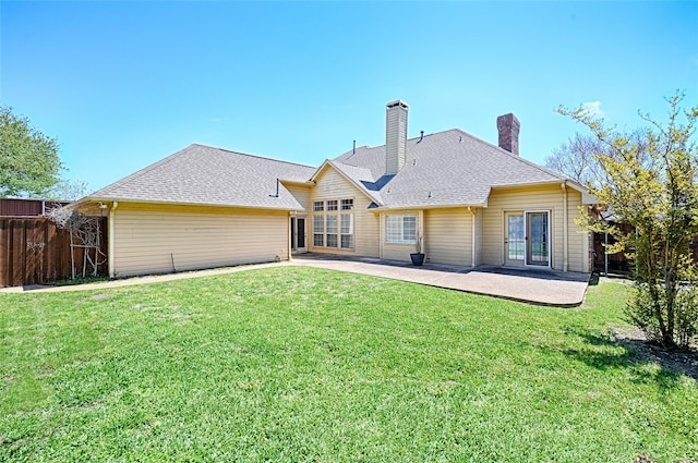 2215 Burgundy Dr, Carrollton, TX 75006 - rear view of house with a yard, fence, a patio, and a chimney