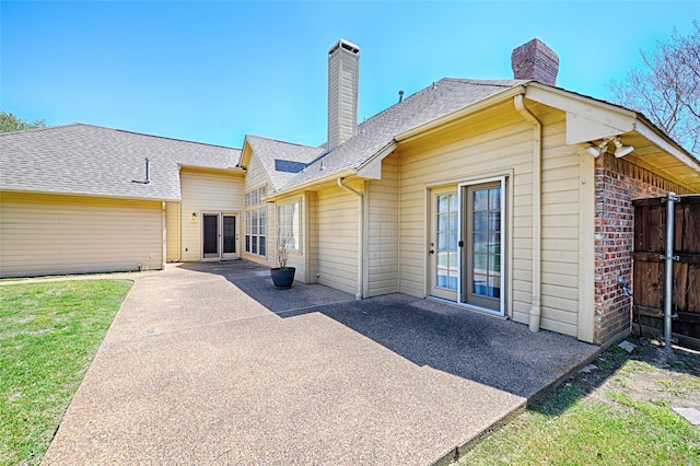 2215 Burgundy Dr, Carrollton, TX 75006 - back of property with a patio area, french doors, and a chimney