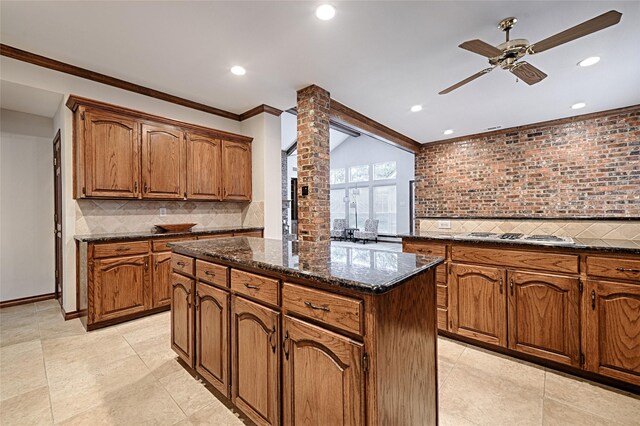 2215 Burgundy Dr, Carrollton, TX 75006 - kitchen featuring tasteful backsplash, stainless steel cooktop, a ceiling fan, and a kitchen island