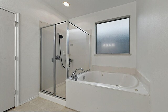 full bath featuring a garden tub and a stall shower