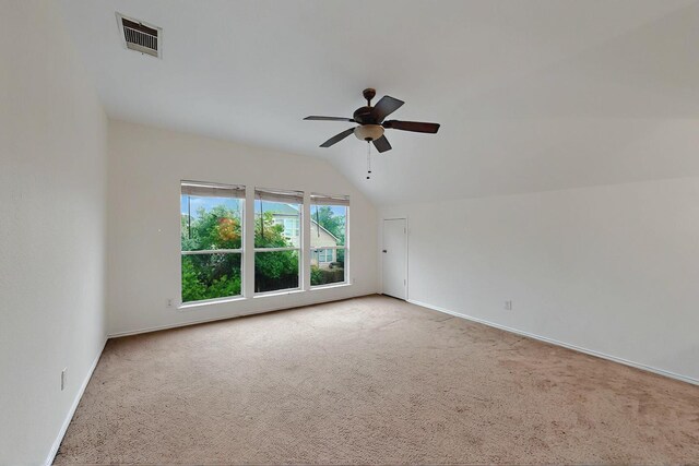 living room with ceiling fan, light carpet, vaulted ceiling, and visible vents