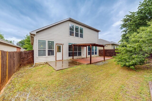 rear view of property with a fenced backyard, a lawn, and a patio area