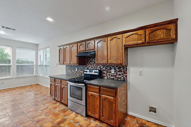 unfurnished living room featuring visible vents, arched walkways, hardwood / wood-style flooring, baseboards, and recessed lighting