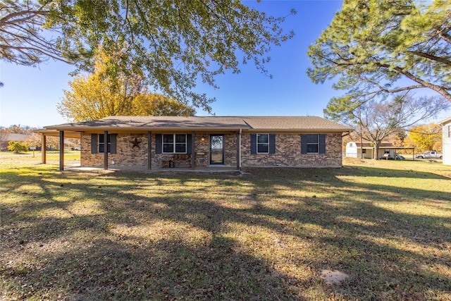 rear view of house with a patio area, brick siding, and a yard