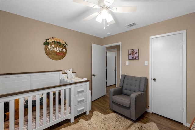 bedroom featuring visible vents, wood finished floors, and ceiling fan