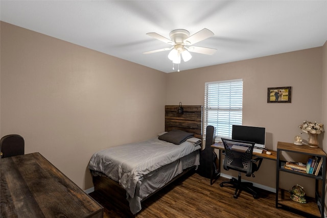 bedroom featuring a ceiling fan, baseboards, and wood finished floors