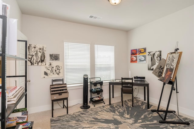carpeted office featuring visible vents and baseboards