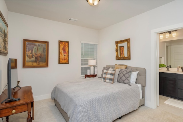 bedroom featuring light carpet, ensuite bathroom, baseboards, and visible vents