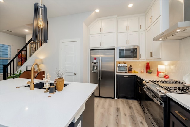 4908 Deavers Ln, Fort Worth, TX 76114 - kitchen with stainless steel appliances, wall chimney range hood, light countertops, light wood-style floors, and white cabinets