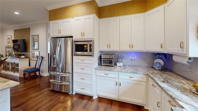 133 Creek Rdg, Waco, TX 76708 - kitchen featuring appliances with stainless steel finishes, crown molding, dark wood-type flooring, light stone countertops, and white cabinets