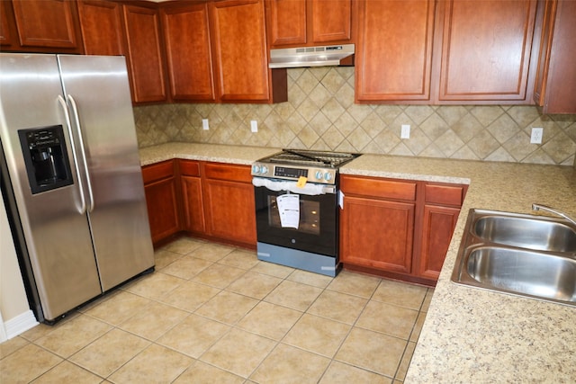 212 Telfair Ln, Bossier City, LA 71112 - kitchen featuring appliances with stainless steel finishes, light tile patterned floors, under cabinet range hood, decorative backsplash, and a sink