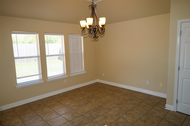 212 Telfair Ln, Bossier City, LA 71112 - unfurnished room with a chandelier, dark tile patterned floors, and baseboards