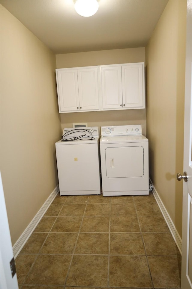 212 Telfair Ln, Bossier City, LA 71112 - laundry area featuring washer and dryer, dark tile patterned flooring, baseboards, and cabinet space
