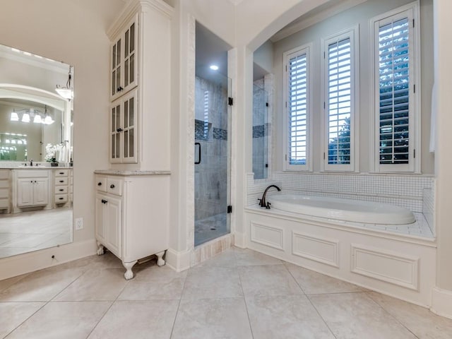 bathroom featuring a shower stall, a bath, vanity, and tile patterned flooring
