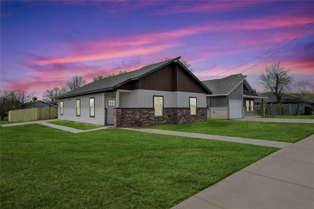 view of front of house with a garage, fence, and a front lawn