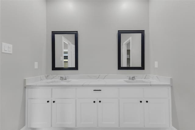 full bathroom featuring double vanity and a sink