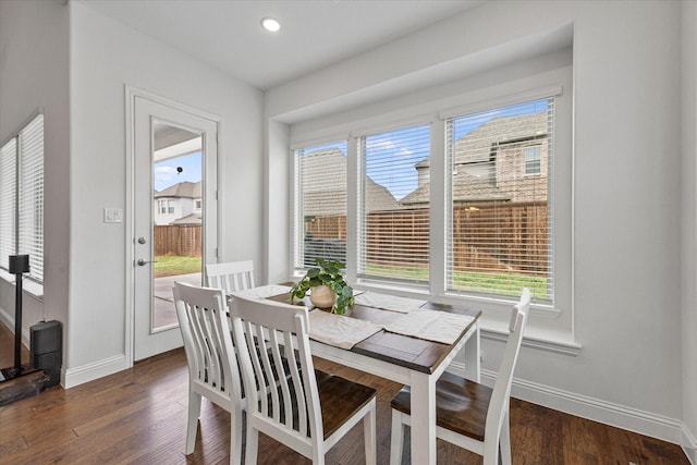 dining room with dark wood-style floors, baseboards, and recessed lighting