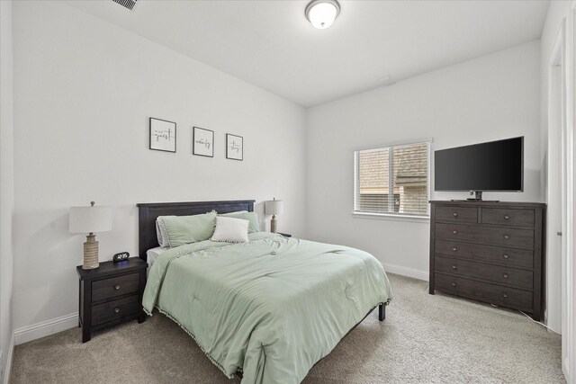 bedroom featuring baseboards and carpet