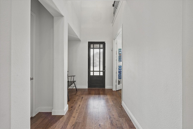 foyer with baseboards and hardwood / wood-style flooring