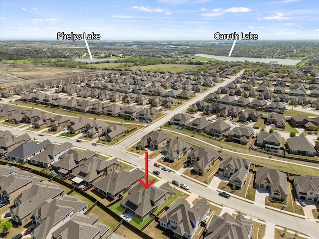 bird's eye view with a residential view and a water view