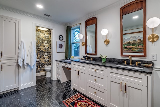 full bath featuring double vanity, visible vents, toilet, and a sink
