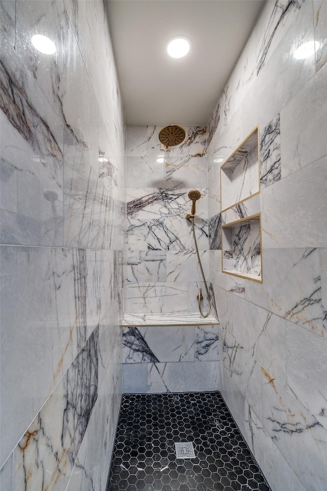 full bath with a marble finish shower
