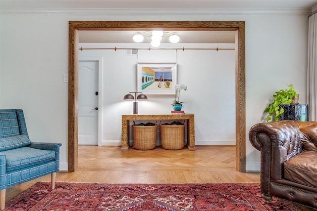 sitting room with baseboards, crown molding, and visible vents