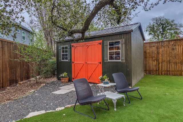 view of shed with a fenced backyard
