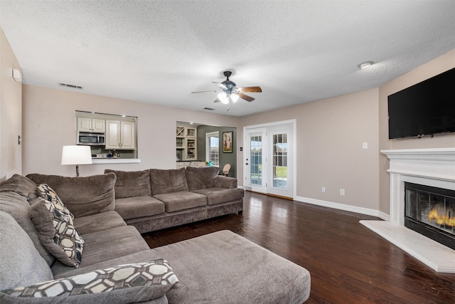 515 Meadow Dr, Lowry Crossing, TX 75069 - living room featuring a ceiling fan, dark wood finished floors, a textured ceiling, a glass covered fireplace, and baseboards