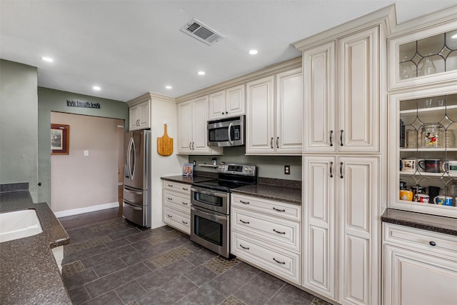 515 Meadow Dr, Lowry Crossing, TX 75069 - kitchen with appliances with stainless steel finishes, cream cabinetry, recessed lighting, and baseboards