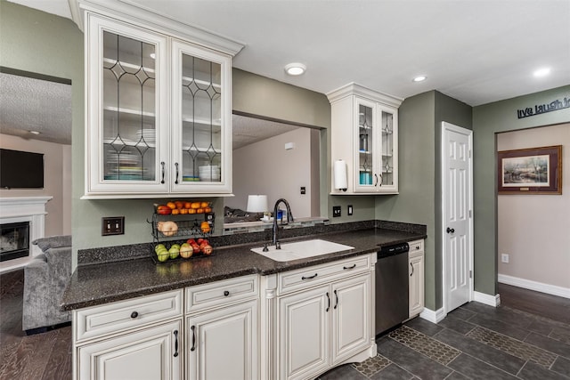 515 Meadow Dr, Lowry Crossing, TX 75069 - kitchen featuring stainless steel dishwasher, a sink, glass insert cabinets, baseboards, and a glass covered fireplace