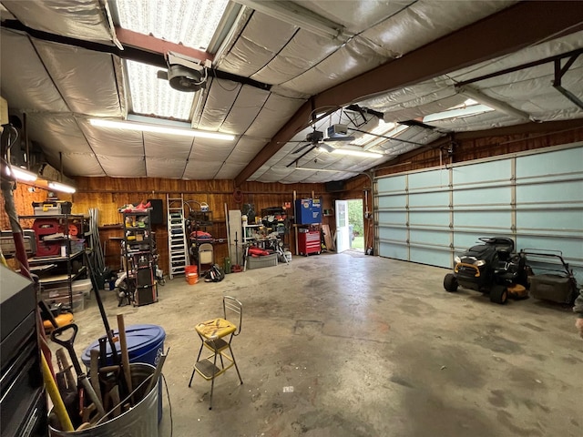 515 Meadow Dr, Lowry Crossing, TX 75069 - garage with wooden walls and a garage door opener
