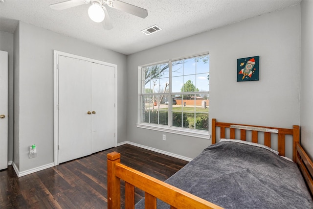 515 Meadow Dr, Lowry Crossing, TX 75069 - bedroom featuring wood finished floors, baseboards, a textured ceiling, a closet, and a ceiling fan