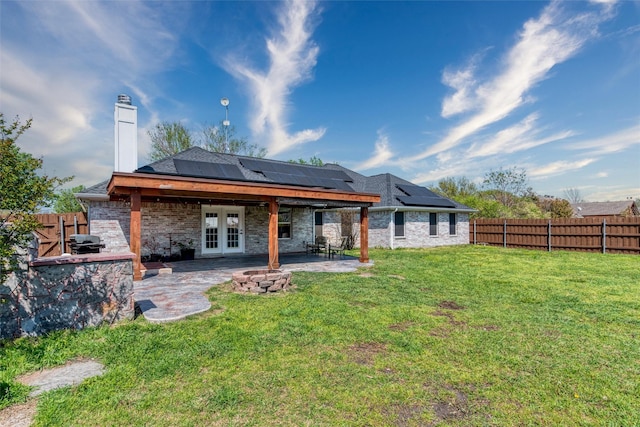 515 Meadow Dr, Lowry Crossing, TX 75069 - rear view of property featuring french doors, a chimney, roof mounted solar panels, a patio, and stone siding
