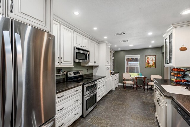 515 Meadow Dr, Lowry Crossing, TX 75069 - kitchen with stainless steel appliances, a sink, glass insert cabinets, white cabinets, and recessed lighting