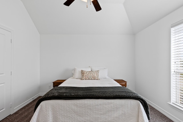 carpeted bedroom featuring baseboards, lofted ceiling, and ceiling fan