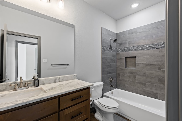 bathroom featuring toilet, vanity, and washtub / shower combination