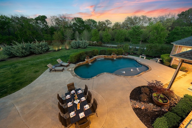 pool with a lawn and a patio area