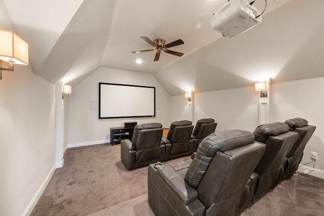 carpeted home theater room featuring a ceiling fan, baseboards, and vaulted ceiling