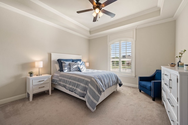 bedroom with baseboards, ornamental molding, a raised ceiling, and light carpet