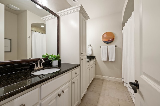 full bathroom featuring vanity, baseboards, tile patterned floors, and visible vents