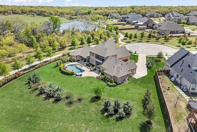 drone / aerial view with a water view and a residential view