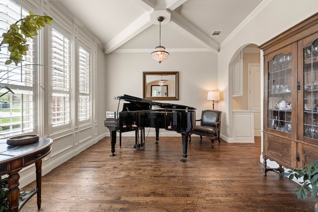 sitting room with arched walkways, plenty of natural light, vaulted ceiling with beams, and dark wood-type flooring