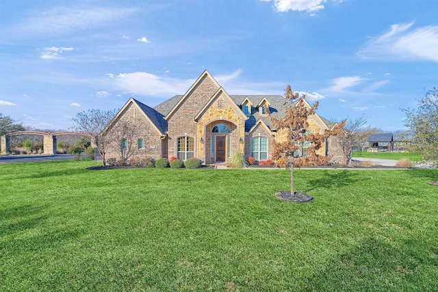 4994 Dogwood Dr, Celina, TX 75009 - french country style house with stone siding, a front yard, and brick siding